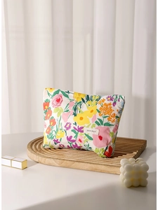 Floral print cosmetic bag for travel with colorful patterns on a wooden tray