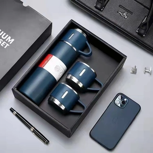 Business gift set with navy blue vacuum flask and two stainless steel mugs in a black box