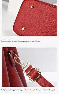 Detail of red litchi grain leather bag with gold metal feet and adjustable strap hooks