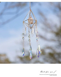 Detail of geometric suncatcher featuring rainbow prism crystals and golden metal frame