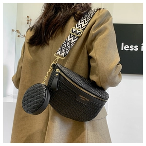 Detail of woven black belt bag with geometric wide strap and mini round coin purse