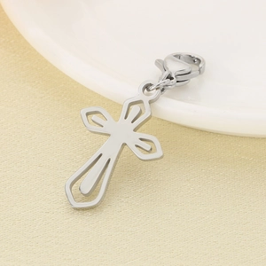 Detail of hollowed-out stainless steel cross pendant with functional lobster clasp accessory
