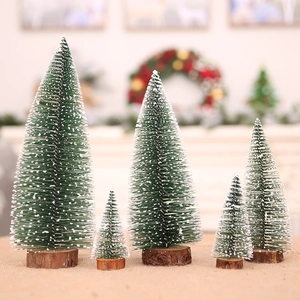 Five assorted snowy mini pine trees with wooden bases for festive tabletop decoration