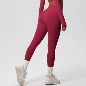 Detail showing high-waisted deep red yoga leggings with a professional lifting effect