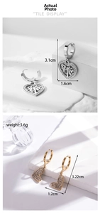 Detailed view of silver tree of life and gold pavé heart earrings with measurements