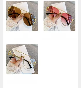 Detail of aviator sunglasses featuring leopard head metal hinges and golden metal frame