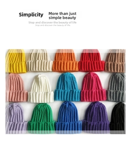 Flat lay of knit beanies in 15 vibrant colors with premium ribbed texture and fold-up cuff