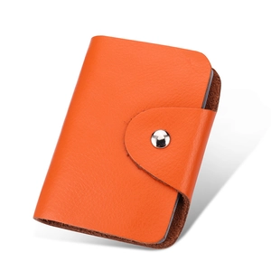 Premium orange genuine leather card holder with metallic snap button and vintage texture