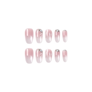Pink and white gradient short press-on nails with floral art and sparkling rhinestones