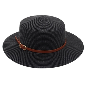Detail of black straw sun hat with brown leather belt and golden buckle texture