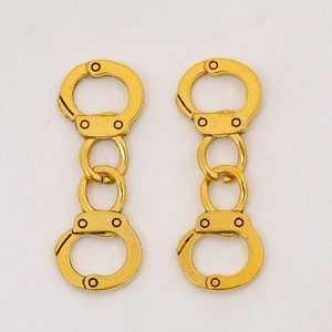 Close-up of golden zinc alloy handcuff pendants for DIY jewelry and earring design