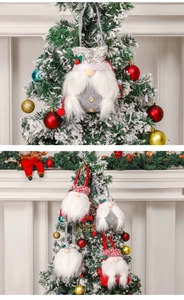 Close-up of knit Christmas gnome gift bags in red and grey with plush beards and sequins
