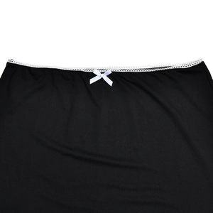 Close-up of black elastic fabric featuring white lace trim and a small center ribbon bow