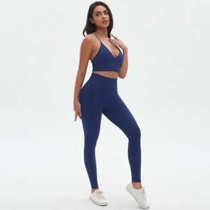 Detailed view of seamless navy blue yoga set with spaghetti strap top and high-waist leggings