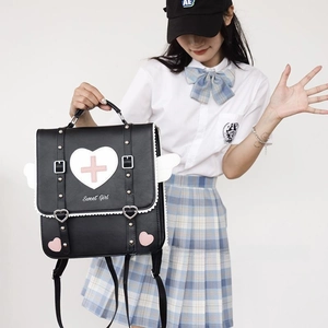 Detail of JK style black leather backpack with white lace edges and heart wing accents