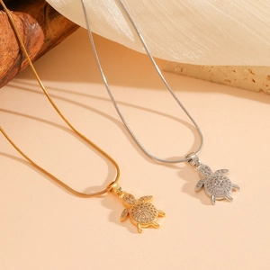 Gold and silver turtle pendant necklaces with crystal inlay on sleek snake chains