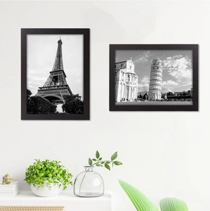 Detail of two black minimalist wall picture frames featuring iconic travel photography