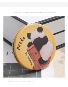 Macro detail of yellow faux leather portable makeup mirror with cute panda illustration