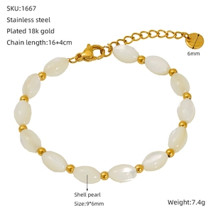 Detail of 18K gold-plated stainless steel bracelet featuring oval shell pearl beads