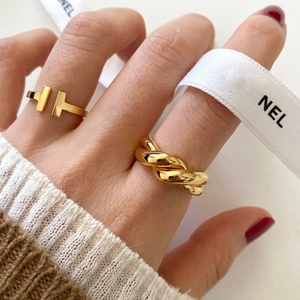 Close-up of T-shaped open ring and twisted rope cross band in 18K gold finish