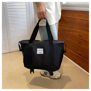 Detail view of black travel bag with smooth rolling wheels and durable handles