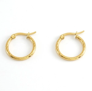 Close-up of gold stainless steel hoop earrings with textured diagonal pattern