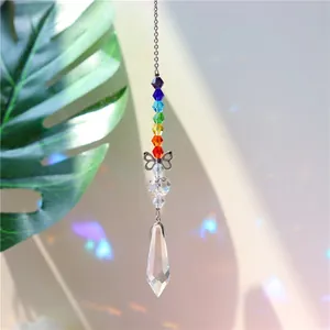 Detail of crystal suncatcher with butterfly accent and rainbow light refraction
