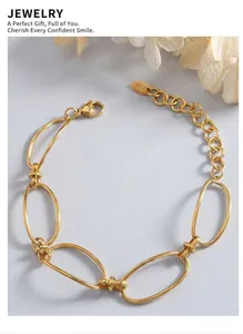 Macro shot of gold-plated thick oval links and K18 tag on a deep blue background