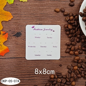 Close-up of 8x8cm white paper jewelry display card with 14 holes for weekly earrings