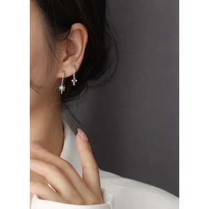Close-up of s925 silver star earrings with colorful gemstones worn by a model