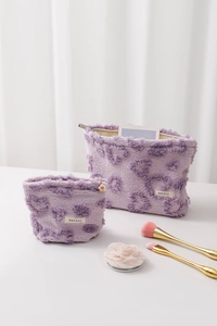Close-up of soft purple plush makeup bags with 3D heart patterns and two sizes