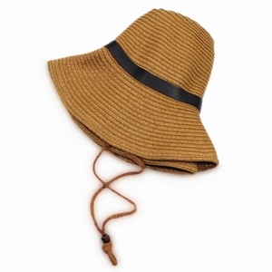 Detail of dark brown straw sun hat with black satin ribbon and adjustable wind rope