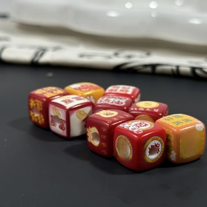 Macro shot of creative acrylic square beads with Chinese lucky charms and colorful patterns