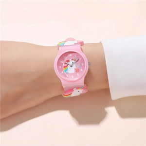 Pink unicorn kids watch with 3D silicone strap and analog dial shown on child wrist