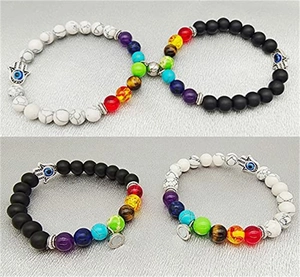 Detail of natural stone magnetic bracelets with heart magnets and Hamsa hand charms