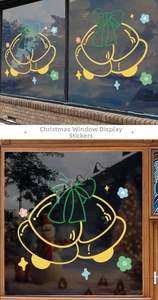 Christmas window decals showing yellow bells and green bows on glass surfaces