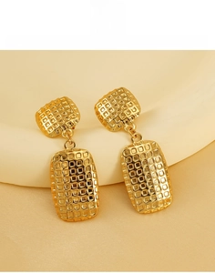 Detailed view of square checkered texture on gold titanium steel earrings for women