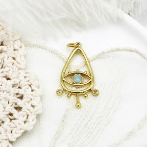Golden teardrop evil eye charm pendant with light blue gemstone and white zircon stones