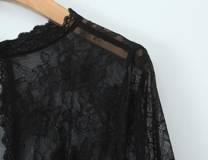 Close-up of black lace fabric and shoulder design on a corset style slim-fit top