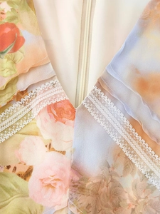 Detail of floral chiffon fabric with white lace trim and centered invisible zipper