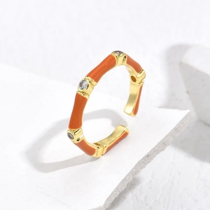 Gold plated bamboo joint ring with orange enamel and cubic zirconia accents
