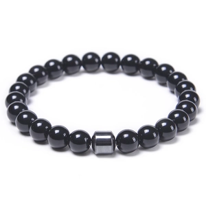 Detail of 8mm polished black agate beads and a metallic hematite spacer on elastic band