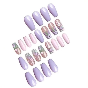Long coffin fake nails with purple floral patterns and glossy finish on white background