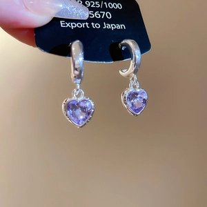 Detail view of S925 sterling silver heart earrings with purple crystal pendants