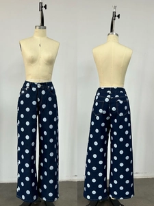 Detailed front and back view of dark blue wide-leg jeans with white polka dot patterns