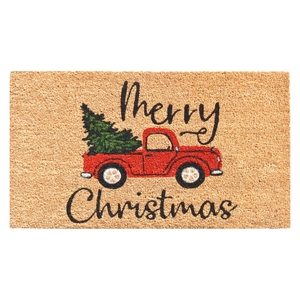 Detail of Merry Christmas door mat with red truck and cedar tree pattern on fiber texture