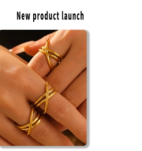 Macro shot of gold-plated crossover rings with smooth interwoven lines and metallic luster