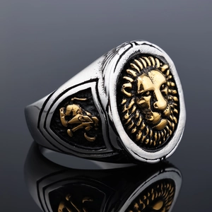 Macro view of vintage lion head seal ring featuring gold relief and silver finish