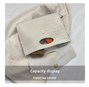 Macro view of white crocodile pattern tote bag interior showing large storage capacity