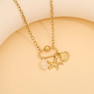 Close-up of golden stainless steel necklace featuring shell, starfish and scallop pendants
